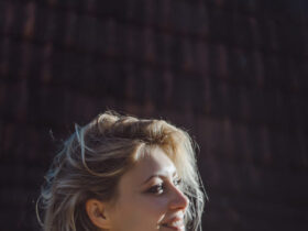 Mulher loira com look gaúcho bebendo chimarrão