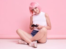 Nulher de cabelo rosa e joystick num estúdio para um ensaio geek