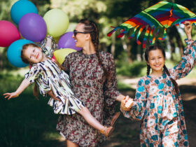 Mãe e filhas com looks floridos aproveitando uma festa infantil a tarde