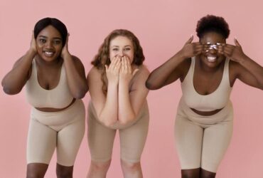 3 mulheres plus size felizes num ensaio fotográfico num estúdio